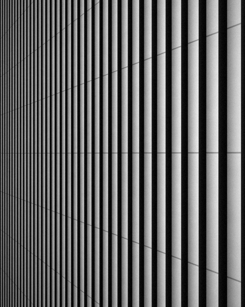 Vertical facade fins in strong light and shadow.