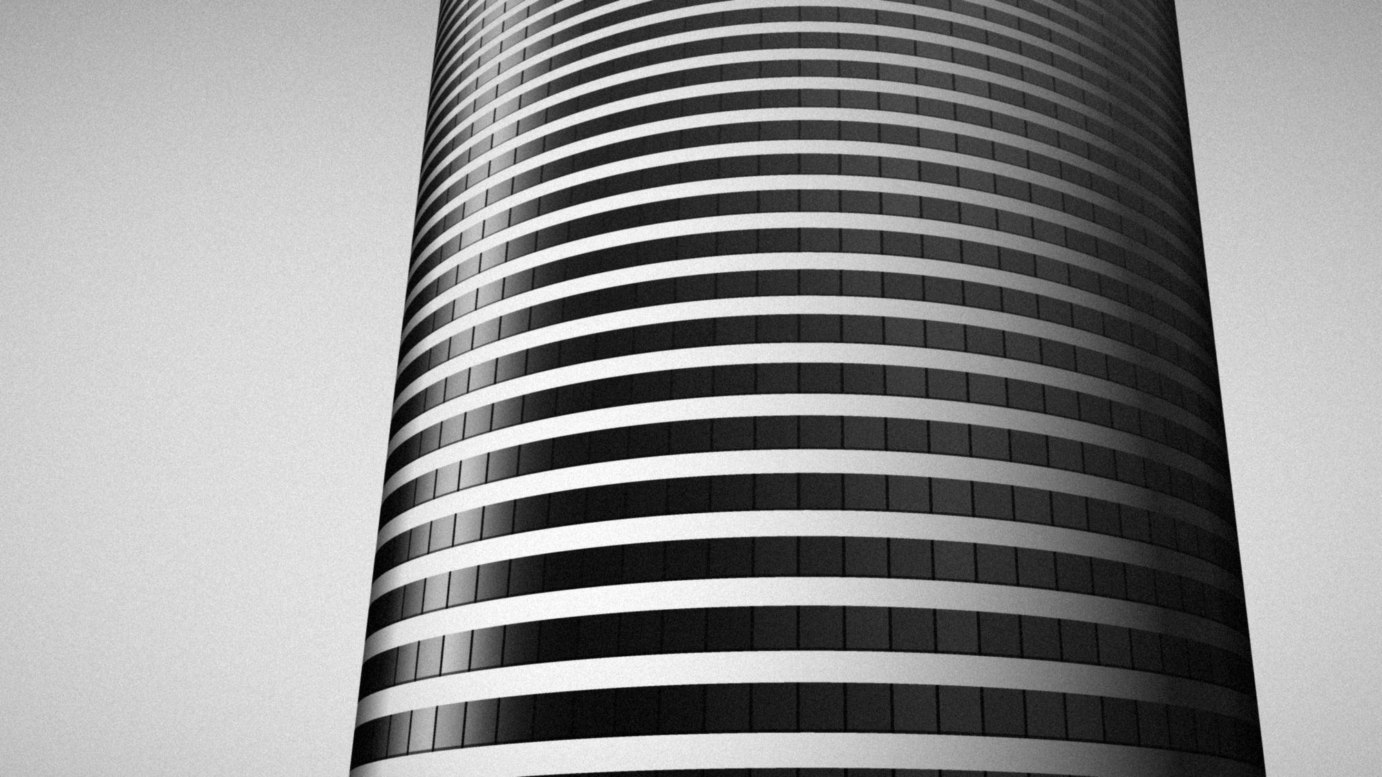 Looking up a round tower banded in stone and glass, in black and white.